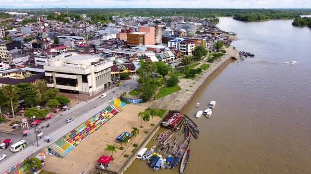 Aerial Majesty of Quibd&oacute;: River, Faith, and Rainforest. Drone views of Quibd&oacute;, Choco, Colombia, featuring the Atrato River, boats, rainforest, and the iconic cathedral. A vibrant mix of nature.