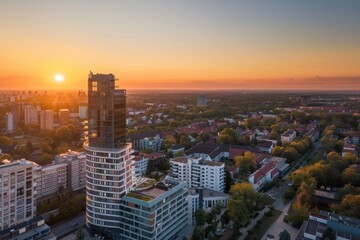 Obraz premium Sunrise Over Cityscape: Aerial View of Modern Architecture at Dawn