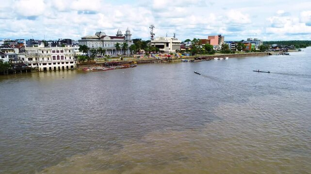 Aerial Majesty of Quibd&oacute;: River, Faith, and Rainforest. Drone views of Quibd&oacute;, Choco, Colombia, featuring the Atrato River, boats, rainforest, and the iconic cathedral. A vibrant mix of nature.