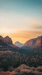 Naklejka premium Sunset illuminates red rock valley, desert vegetation.