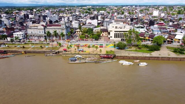 Aerial Majesty of Quibd&oacute;: River, Faith, and Rainforest. Drone views of Quibd&oacute;, Choco, Colombia, featuring the Atrato River, boats, rainforest, and the iconic cathedral. A vibrant mix of nature.