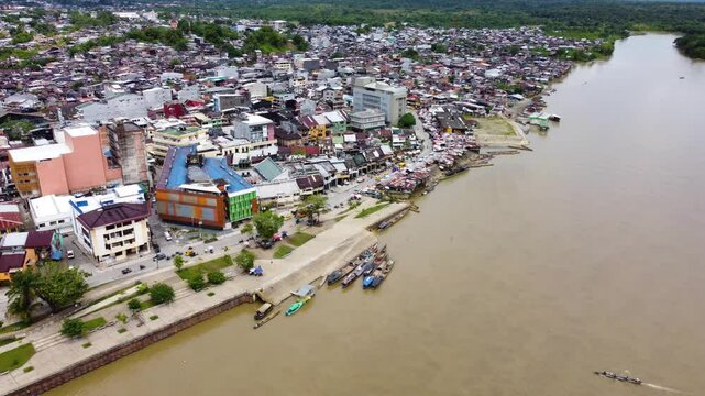 Aerial Majesty of Quibd&oacute;: River, Faith, and Rainforest. Drone views of Quibd&oacute;, Choco, Colombia, featuring the Atrato River, boats, rainforest, and the iconic cathedral. A vibrant mix of nature.
