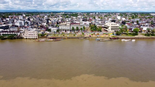 Aerial Majesty of Quibd&oacute;: River, Faith, and Rainforest. Drone views of Quibd&oacute;, Choco, Colombia, featuring the Atrato River, boats, rainforest, and the iconic cathedral. A vibrant mix of nature.