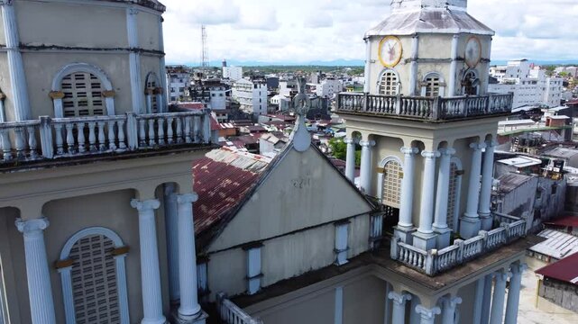 Aerial Majesty of Quibd&oacute;: River, Faith, and Rainforest. Drone views of Quibd&oacute;, Choco, Colombia, featuring the Atrato River, boats, rainforest, and the iconic cathedral. A vibrant mix of nature.