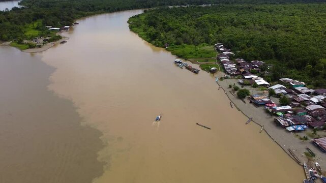 Aerial Majesty of Quibd&oacute;: River, Faith, and Rainforest. Drone views of Quibd&oacute;, Choco, Colombia, featuring the Atrato River, boats, rainforest, and the iconic cathedral. A vibrant mix of nature.