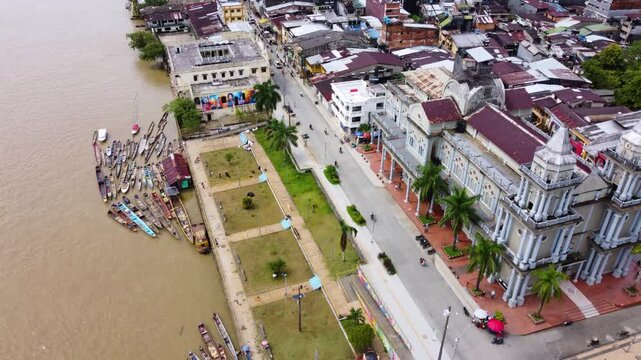 Aerial Majesty of Quibd&oacute;: River, Faith, and Rainforest. Drone views of Quibd&oacute;, Choco, Colombia, featuring the Atrato River, boats, rainforest, and the iconic cathedral. A vibrant mix of nature.