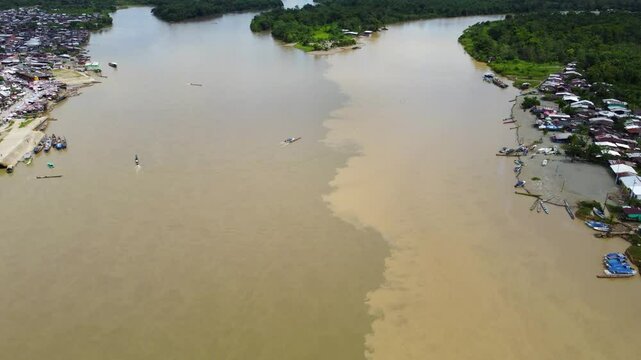 Aerial Majesty of Quibd&oacute;: River, Faith, and Rainforest. Drone views of Quibd&oacute;, Choco, Colombia, featuring the Atrato River, boats, rainforest, and the iconic cathedral. A vibrant mix of nature.