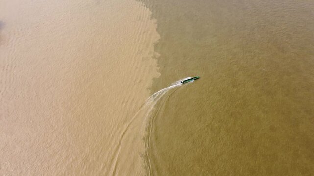 Aerial Majesty of Quibd&oacute;: River, Faith, and Rainforest. Drone views of Quibd&oacute;, Choco, Colombia, featuring the Atrato River, boats, rainforest, and the iconic cathedral. A vibrant mix of nature.