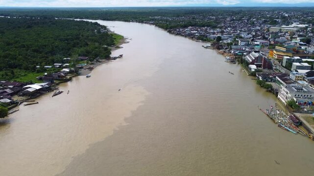 Aerial Majesty of Quibd&oacute;: River, Faith, and Rainforest. Drone views of Quibd&oacute;, Choco, Colombia, featuring the Atrato River, boats, rainforest, and the iconic cathedral. A vibrant mix of nature.