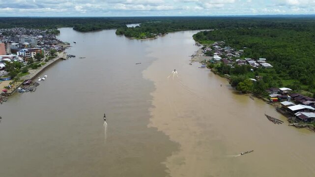 Aerial Majesty of Quibd&oacute;: River, Faith, and Rainforest. Drone views of Quibd&oacute;, Choco, Colombia, featuring the Atrato River, boats, rainforest, and the iconic cathedral. A vibrant mix of nature.
