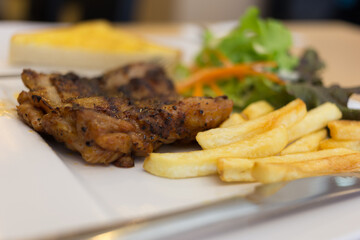 Grilled chicken platter dine-in restaurant food photography urban setting close-up view culinary delight