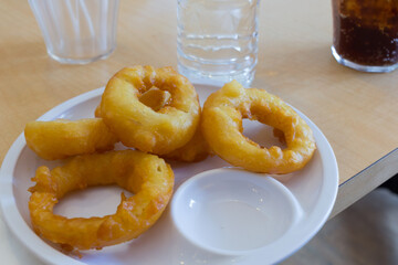Indulging in freshly made doughnuts, local bakery, food photography, bright setting, close-up view, culinary delight