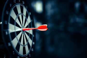 Bulls eye target goal or dartboard has dart arrow throw hitting center shooting for strategy...