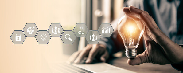 Hand chooses light bulb or lamp icons with business growth icons for human resources or leadership and creativity thinking idea motivation or vision and knowledge learning.