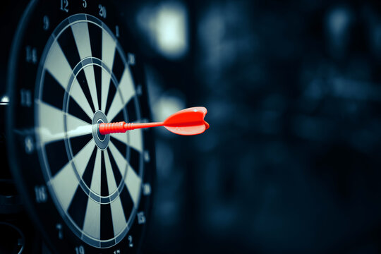 Bulls eye target goal or dartboard has dart arrow throw hitting center shooting for strategy organization management of financial business targeting planning to winner concept.