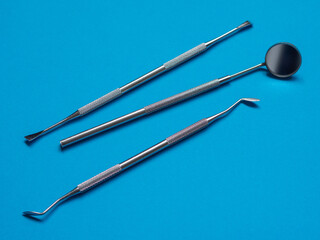 Dental tools on the blue background. Dental services and specialists. Oral hygiene concept