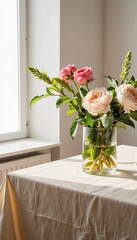 Elegant flower arrangement in glass vase on table by window  