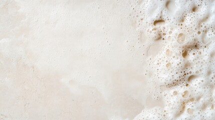 Creamy, foamy texture.  A light beige, frothy surface with bubbles