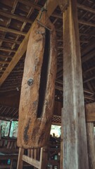 Traditional wooden slit drum hanging inside an open-air pavilion, creating a rustic and cultural atmosphere, a symbol of heritage and craftsmanship