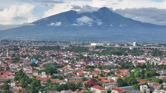 Aerial shot of Bogor with Mount Salak in the background -move backward