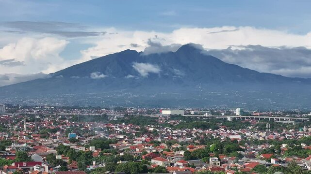 Aerial shot of Bogor with Mount Salak in the background -slide right