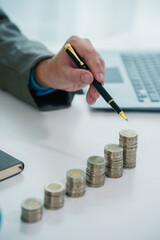 Close up of hands counting money with calculator and piggy bank on table, wealth management, financial planning