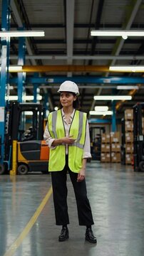 female warehouse worker with helmet and safety vest.
