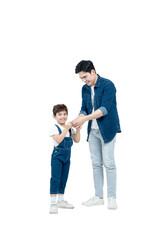 Full body image of Asian father and son walking and posing on white background