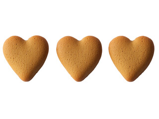 Obraz premium Three Golden Heart-Shaped Cookies on Black Background A Sweet Treat for Valentine's Day or any Romantic Occasion