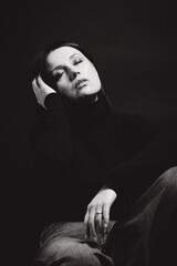 Portrait of a woman with dark hair, done in low key style.