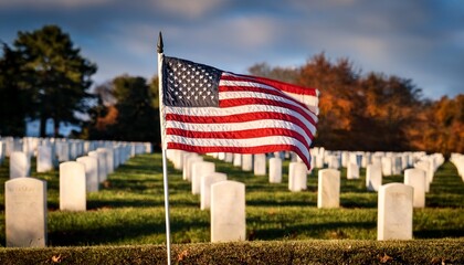 An American flag waving proudly in the foreground, with a background of blurred gravestones at a military cemetery