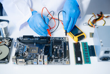 The technician repairing the motherboard in the lab with copy space. the concept of computer...