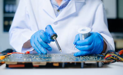 The technician is putting the CPU on the socket of the computer motherboard. electronic engineering...