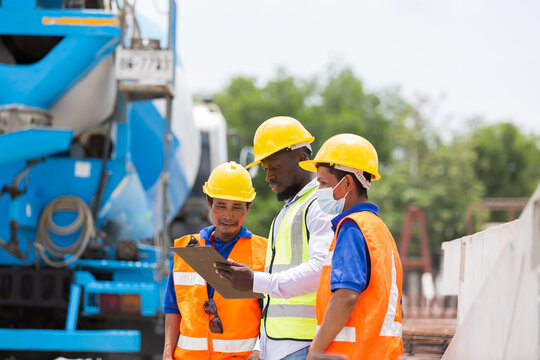 Engineer, Teamwork, Construction site. Team of engineer construction inspecting construction of precast concrete walls at construction site. Foreman builder control of work at site work