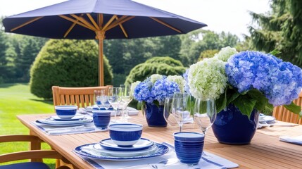Fototapeta premium Elegant outdoor dining setup with blue and white tableware, surrounded by lush greenery and flowers