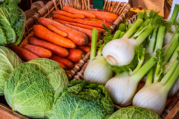 Freshly harvested vegetables displayed at a local market, showcasing vibrant colors and organic...