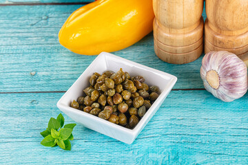 Pickled canned capers in the bowl