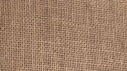 Hessian sackcloth woven fabric texture background in beige cream brown color photo. Burlap texture background.