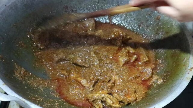 The process of cooking rendang is by stirring it in a pan. Rendang is a typical Indonesian food made from beef and various spices and coconut milk, one of the world's most famous culinary delights
