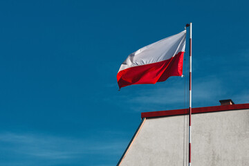  Polish National Flag Waving on a Sunny Day – Patriotic Symbol of Poland