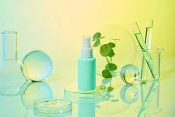Laboratory concept with cosmetic spray bottles placed together with petri dishes, beaker, test tubes, glass ball and florence flask. Gotu kola is an organic ingredient with many uses for skincare.