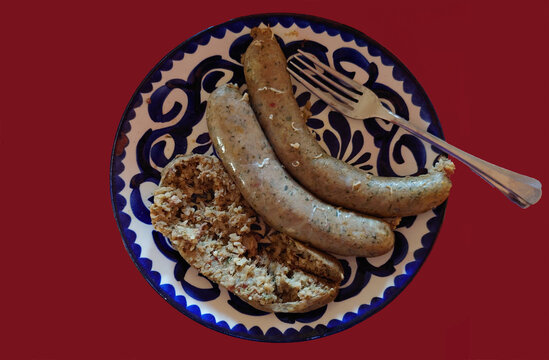 plate of cooked pork boudin (Cajun pork and rice sausage) with one open link showing contents