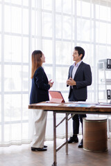 Team of financial advisory services. Asian advisor showing plan of investment to clients in the consultancy office.
