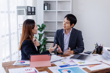 Team of financial advisory services. Asian advisor showing plan of investment to clients in the consultancy office.
