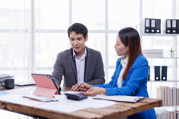 Team of Accounting business are calculating income-expenditure and analyzing real estate investment data on tablet computer, Financial and tax systems concept.
