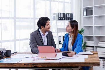 Team of Accounting business are calculating income-expenditure and analyzing real estate investment data on tablet computer, Financial and tax systems concept.
