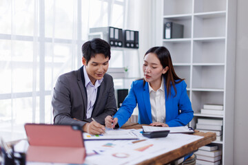 Fototapeta premium Team of Accounting business are calculating income-expenditure and analyzing real estate investment data on tablet computer, Financial and tax systems concept. 