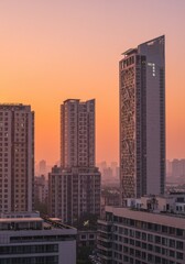 Fototapeta premium Orange And Pink Sunset Over City Skyline