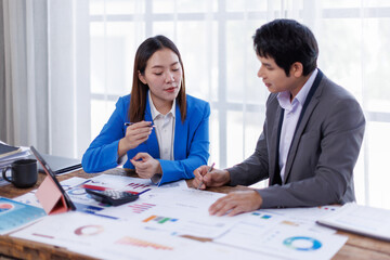 Business finance accounting banking concept. Business hand doing finances and calculate on desk about cost at office. Two Business working on desk with using calculator, finance accounting.