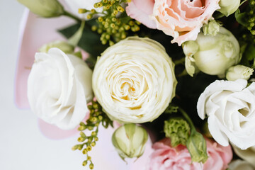 Fresh floral arrangement featuring roses and greenery in a soft color palette